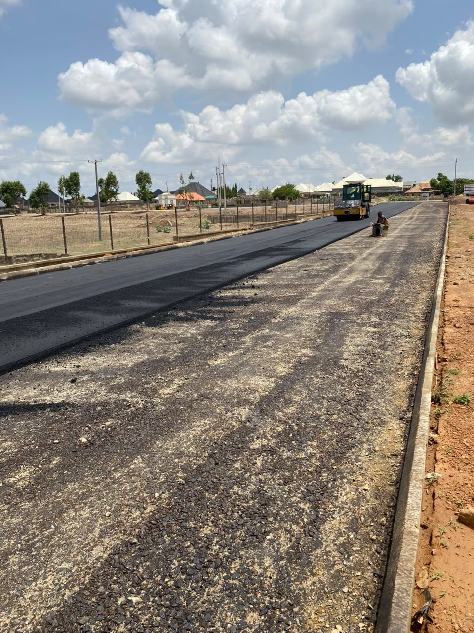 Completed asphalt road running through an estate