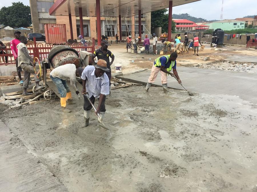 Crew placing and finishing the forecourt concrete