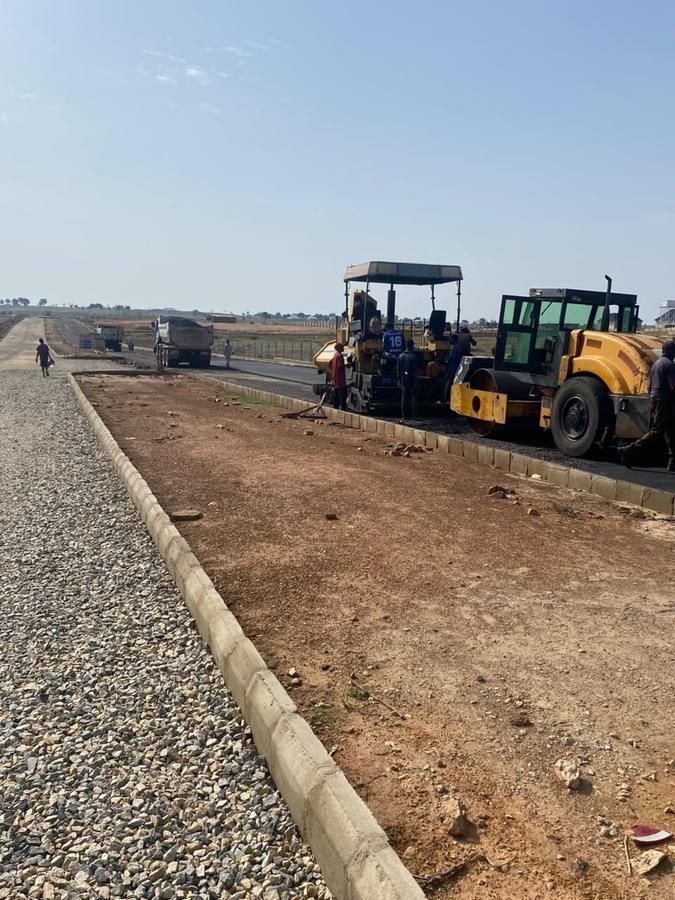 Paver and roller staged at the kerb line